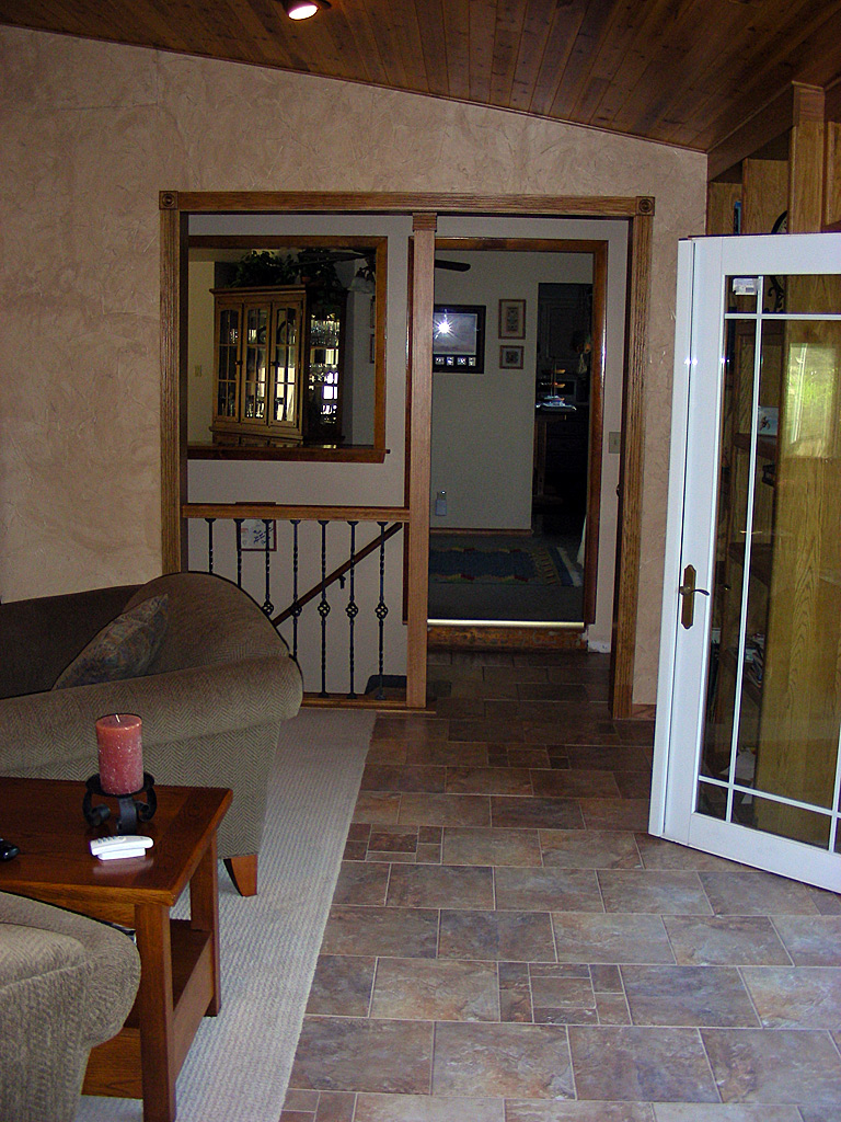 Tile hallway floor leading into the house